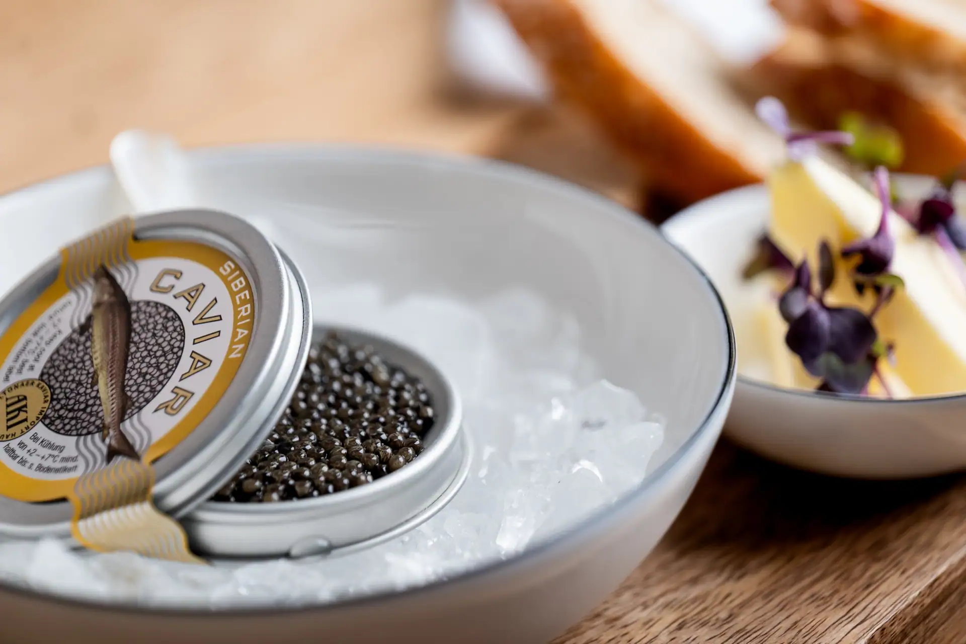 Open tin of AKI Siberian caviar on ice