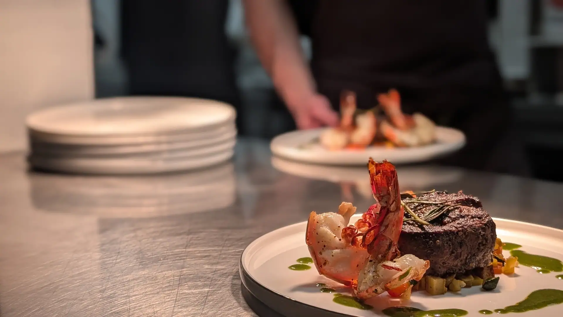 A plate at the pass, the kitchen in the background