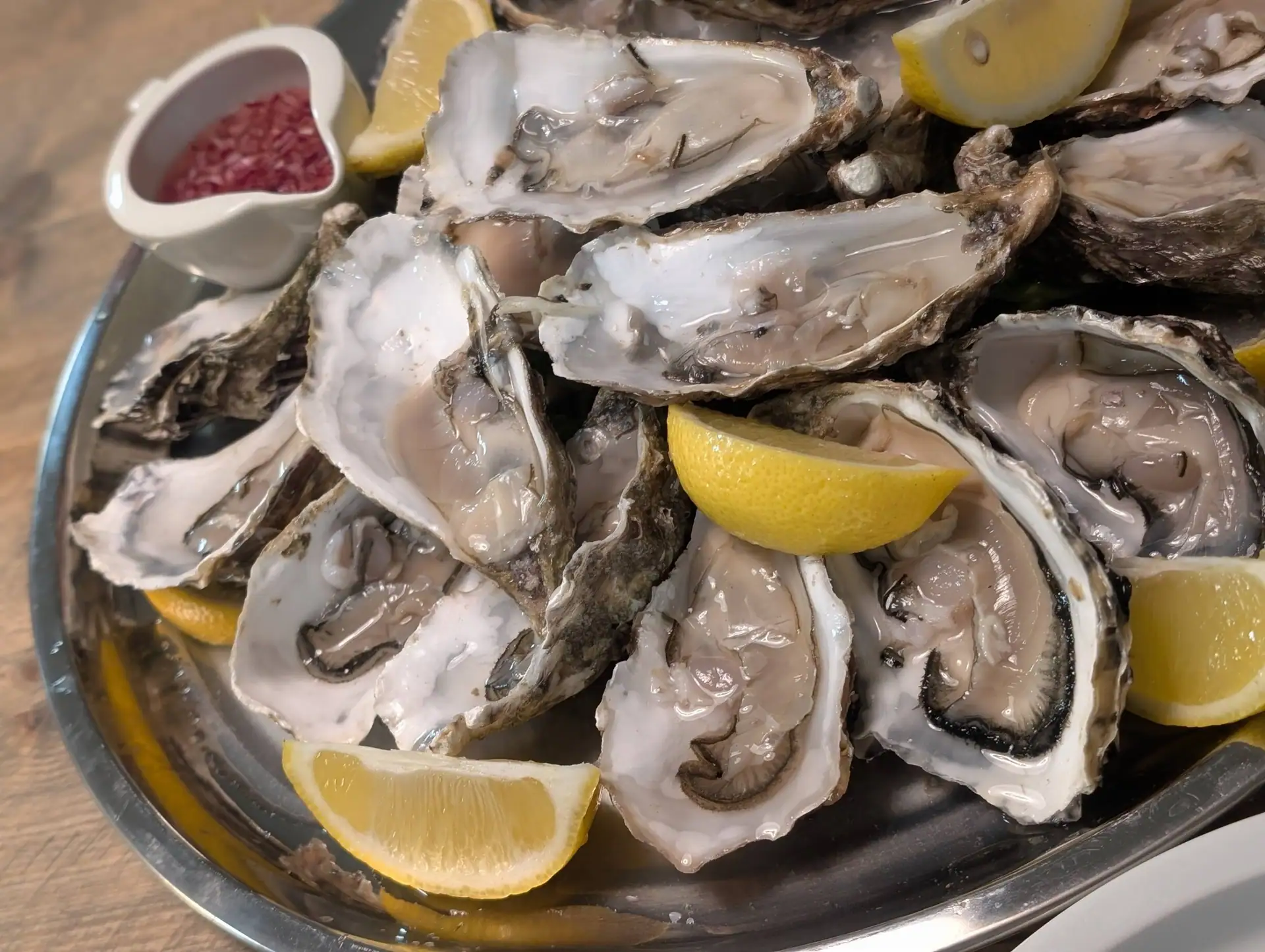 Freshly opened oysters on ice with lemon